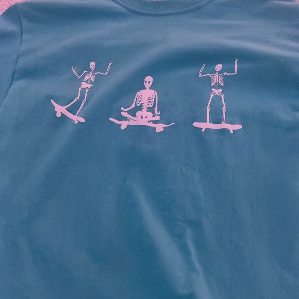 teal and white skelton graphic tee